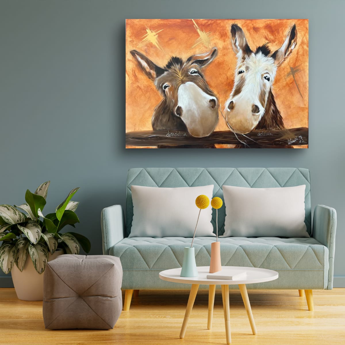 “Commissioned painting of Dandelion and Delilah, two donkeys in warm orange tones, displayed in a modern living room; available as a print and limited edition.”
